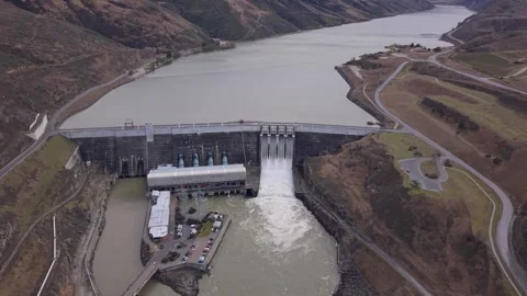 Hydro Power Dam and Four Open Spill Gates Revealing Dramatic Water Level Stock Footage 345665837