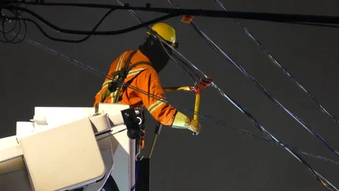 Hydro Quebec crew cuts power wire line at night from bucket Stock Footage 127252263