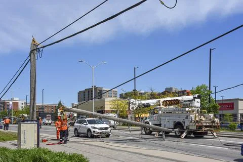 Hydro workers replacing downed power pole snapped by wind in Ottawa after sev Stock Photos