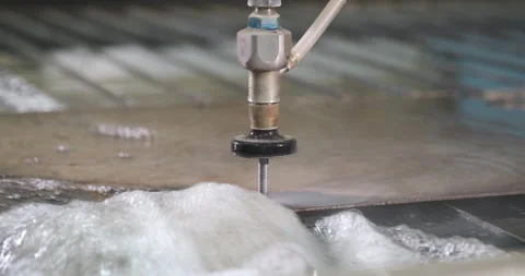 Hydroabrasive high pressure CNC machine is cutting out a shape on a metal sheet. Video stock 178995971