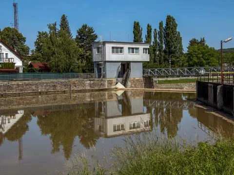 Hydroelectric Control Building Reflected in Calm River Water Stock Photos