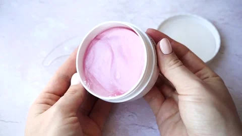 Hydrogel pink cosmetic eye patch jar in female hands. Stock Footage 150259392