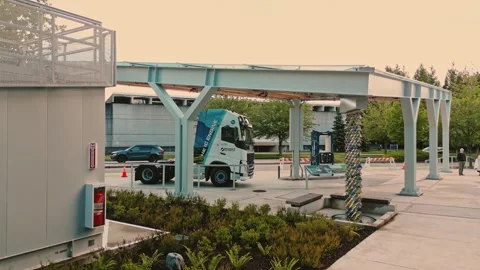 Hydrogen compressor building standing near smart refueling canopy captured by Vídeo Stock 334513986