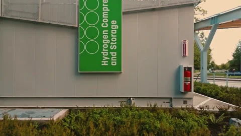 Hydrogen compressor signage displayed tan facility building captured by Vídeo Stock 333943056