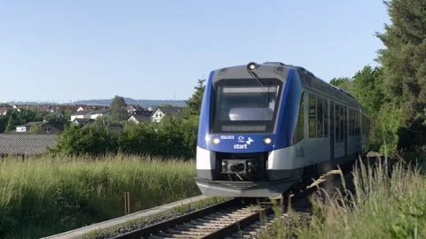 Hydrogen train driving through town Stock Footage 242753142
