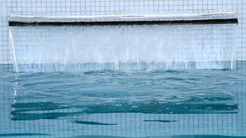 Hydromassage shower in the pool. blue clean water flows into the pool Stock Footage 92498437