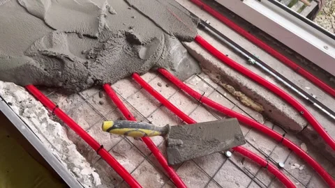 Hydronic heated windowsill pipe installation on metal mesh Stock Footage 346719063