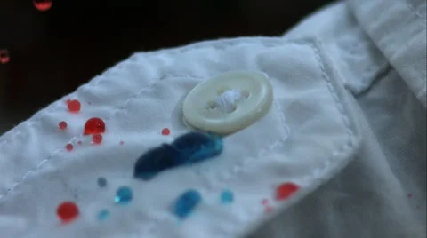 Hydrophobic fabric is splashed with red and blue droplets Stock Footage 64872107