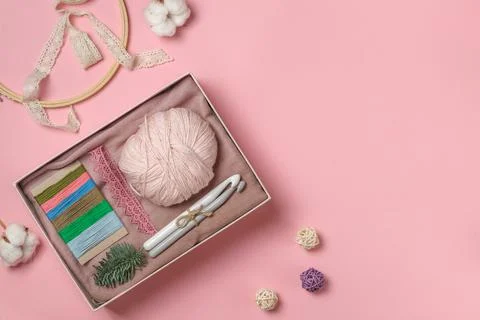 Hygge box, a gift set for needlework on a pink pastel background. Top view with Stock Photos