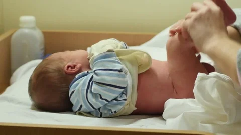 Hygienic procedures with 2 days old newborn on table in hospital Stock Footage 71588704