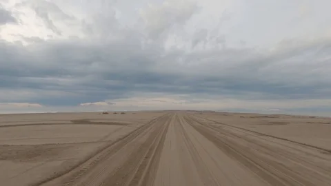Hypelapse back forth driving empty beach Stock Footage 123357662
