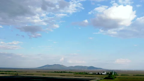 Hyper lapse aerial view over agriculture fields, blue sky and clouds Stock Footage 160406058