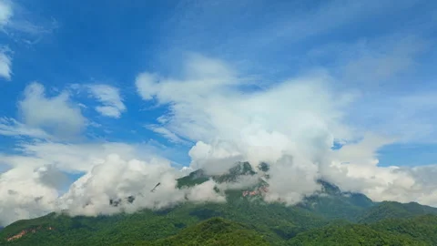 Hyper lapse Arial view of Mist drifts over the towering Doi Luang Chiang Dao. Stock Footage 295998726