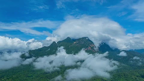 Hyper lapse Arial view of Mist drifts over the towering Doi Luang Chiang Dao. Stock Footage 302277317