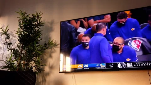 Hyper lapse of a basketball game being played on a big TV in a modern house Stock Footage 201732052