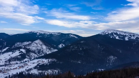 Hyper lapse of clouds running on blue sky over amazing landscape of snowy Stock Footage 104657384