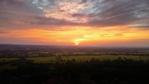 Hyper lapse, Colorful sunset on the top of the rural village on a green field. Stock Footage 166018923