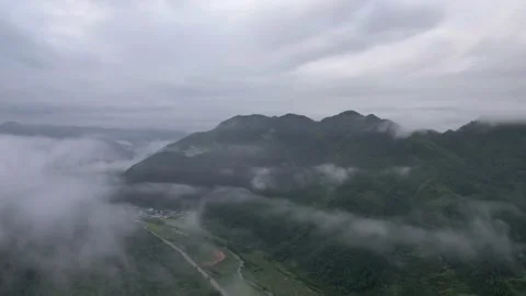 Hyper lapse drone view of villages and farmlands among green mountain valley Stock Footage 285195741