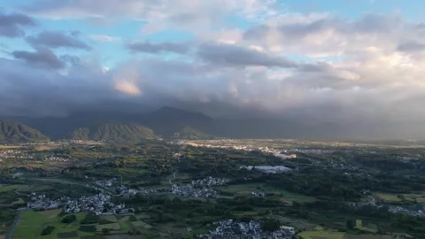 Hyper lapse drone view villages and farmlands among green mountains Stock Footage 285575399