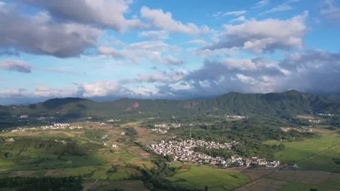 Hyper lapse drone view villages and farmlands among green mountains Stock Footage 285575422