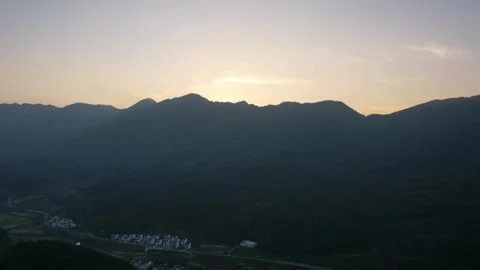 Hyper lapse drone view of villages and farmlands among green mountain valley Stock Footage 285587323