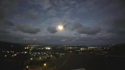 Hyper Lapse from dusk to moon clouds and traffic rolling past Stock Footage 260374227
