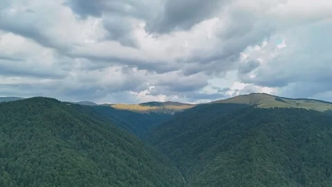 Hyper lapse with dynamic moving rain clouds over a valley covered by forest Stock-Footage 298484792