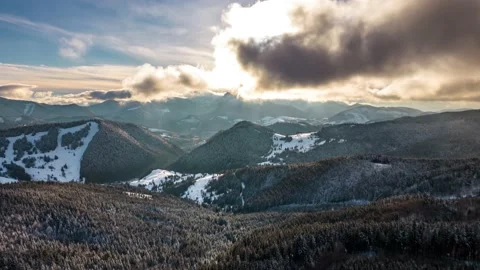 Hyper lapse of fast clouds above winter forest nature in sunny mountains Stock Footage 230918904