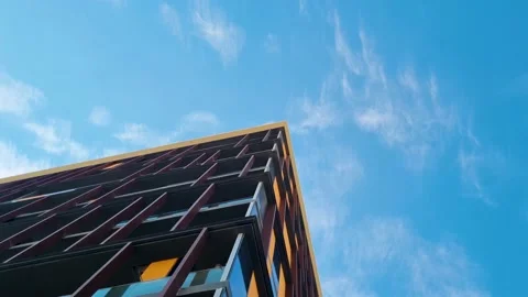 Hyper lapse footage of the clouds moving above the modern building. Concept Stock Footage 231014097