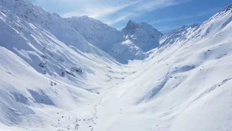 Hyper lapse at low altitude towards snowy mountain peak Stock Footage 134984438