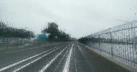 Hyper lapse of metro train driving fast on railway tracks on rainy day with r Stock Footage 299503554