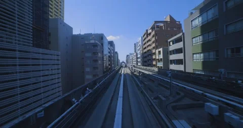 A hyper lapse of a moving forward urban monorail at the downtown in Tokyo by POV Stock Footage 331432791