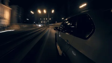 Hyper-lapse from a moving luxury car driving on a city street at night Stock Footage 125995324