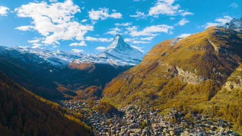 Hyper lapse or drone time lapse aerial view of Zermatt village in autumn season. Stock Footage 264020654