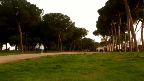 Hyper lapse, People walk , jog  and ride bikes in a park,at sunset Stock Footage 104029343