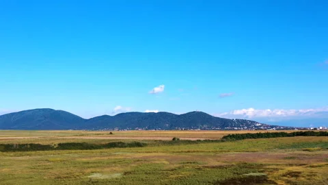 Hyper lapse - a plain with a mountain in the background on a beautiful sunny day Stock Footage 138074945
