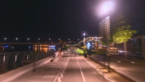 Hyper lapse of promenade by the river at night	 Stock Footage 127827474