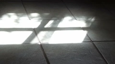 Hyper lapse of shadows from sunshine through a window on a tiled ground Stock Footage 135662707