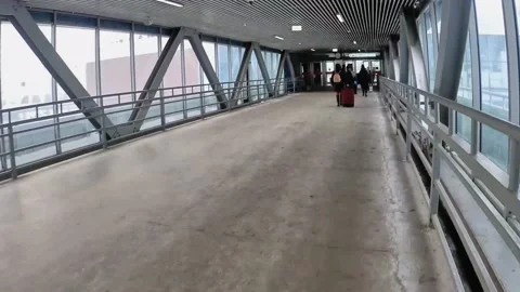 Hyper lapse video of pedestrian motion along transparent bridge to entrance o Stock Footage 149251196