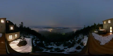 Hyper-lapse of winter fog at night from lodge overviewing city in mountains Stock Footage