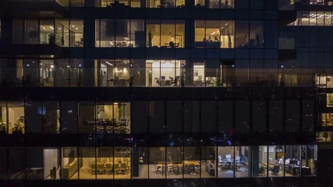 [Hyper Lapse] Workers at office building at night, aerial view trough a window Stock Footage 120882537