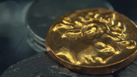Hyper Macro Gold coin on a pile of Silver metal ancient coins, old drawings Stock Footage 305251805