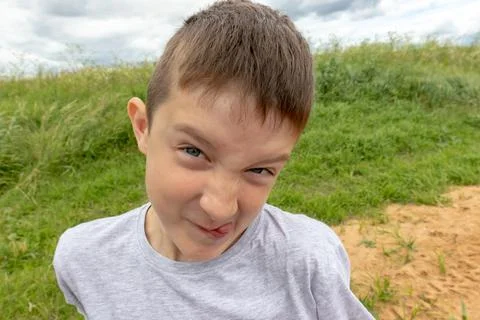An hyperactive boy making faces, misbehaves and goes crazy Stock Photos