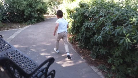Hyperactive child, boy running in the park. SLow motion Stock Footage 255429915