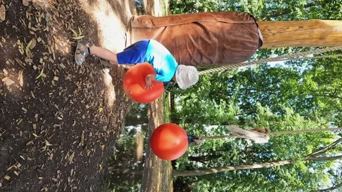 A hyperactive child in a park. Energy, physical development, coordination, joy Stock Footage 333263879