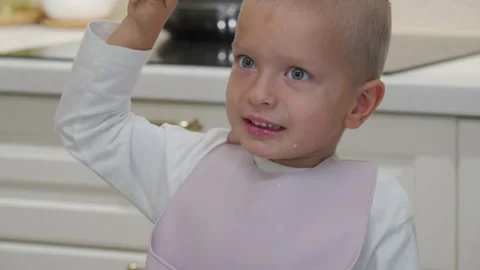 Hyperactive excited child at dinner table. Stock Footage 296472948