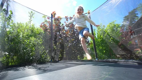 Hyperactive girl acrobatic jumping on outdoor trampoline. Handheld shot. Stock Footage 109556745