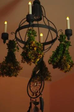 Hypericum on chandelier with candles Stock-Fotos