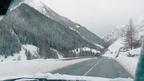 A hyperlaps in the car in the middle of snow-capped mountains Video stock 138511904