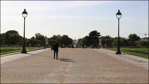 Hyperlaps of people walking between the tile garden and the Louvre museum Stock Footage 130751590
